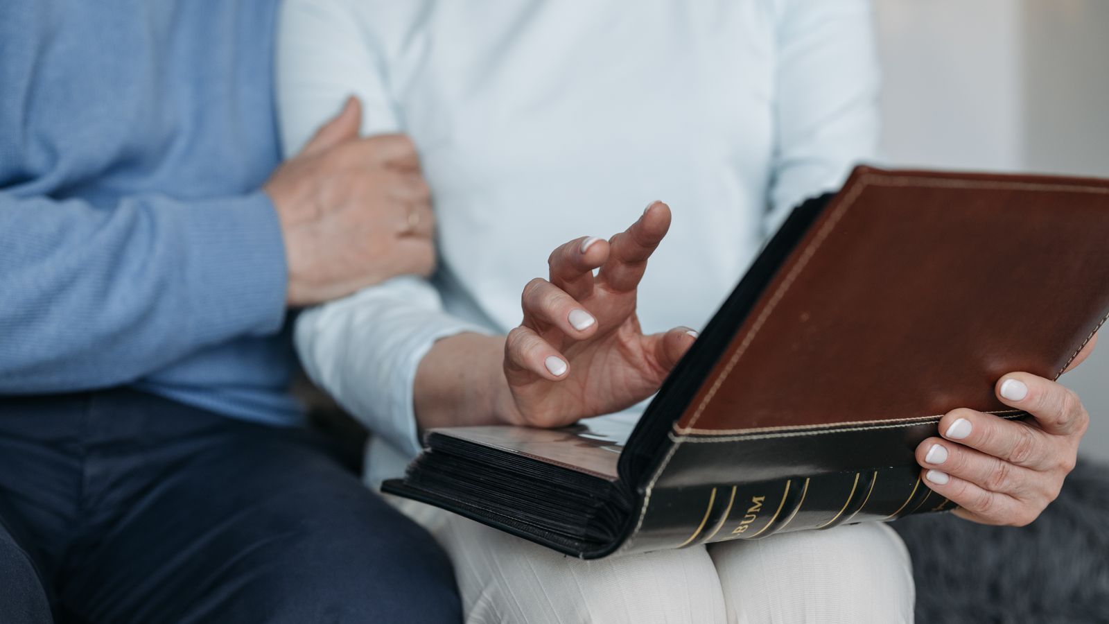 Hands holding an open photo album