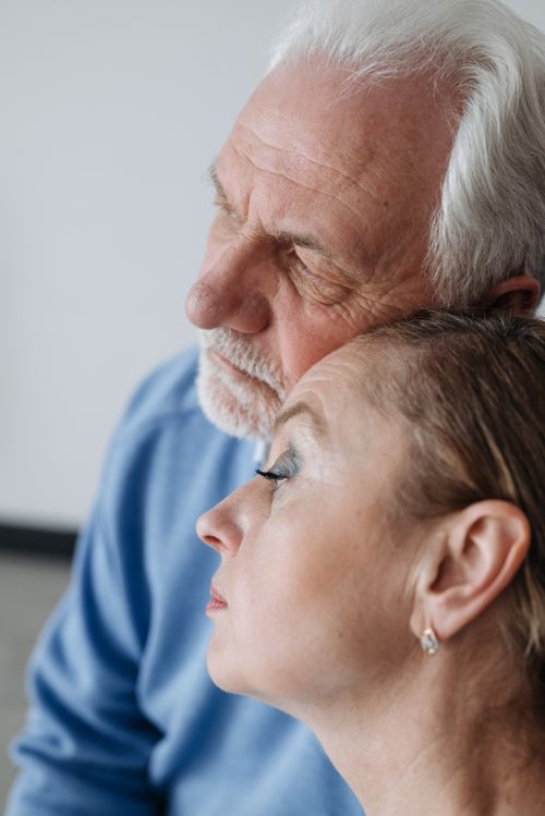 Free Senior couple embracing each other in a moment of emotion indoors. Stock Photo