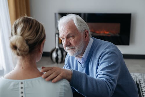 Elderly Man Comforting a Woman