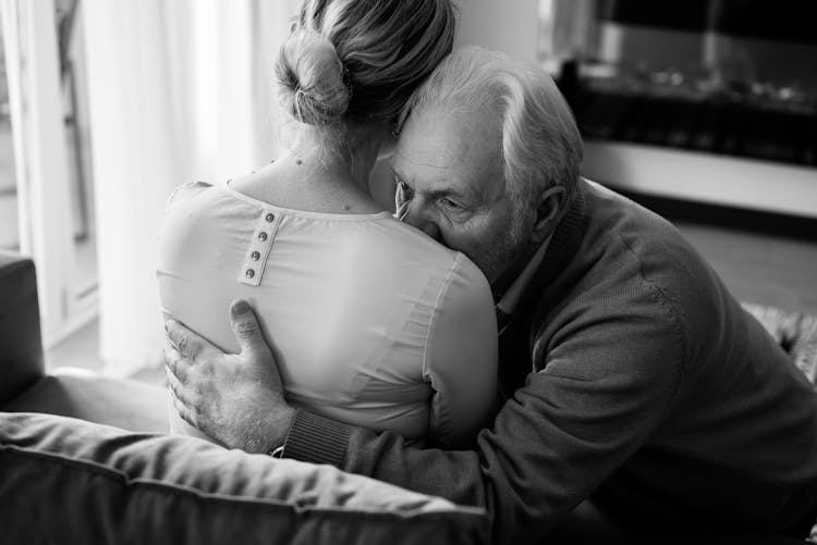 A Man Consoling His Wife With A Hug