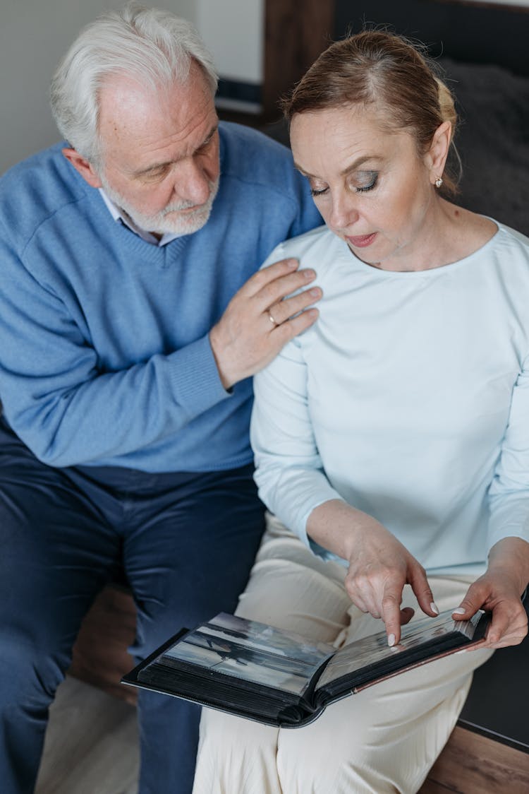 Couple Looking At Album Photos