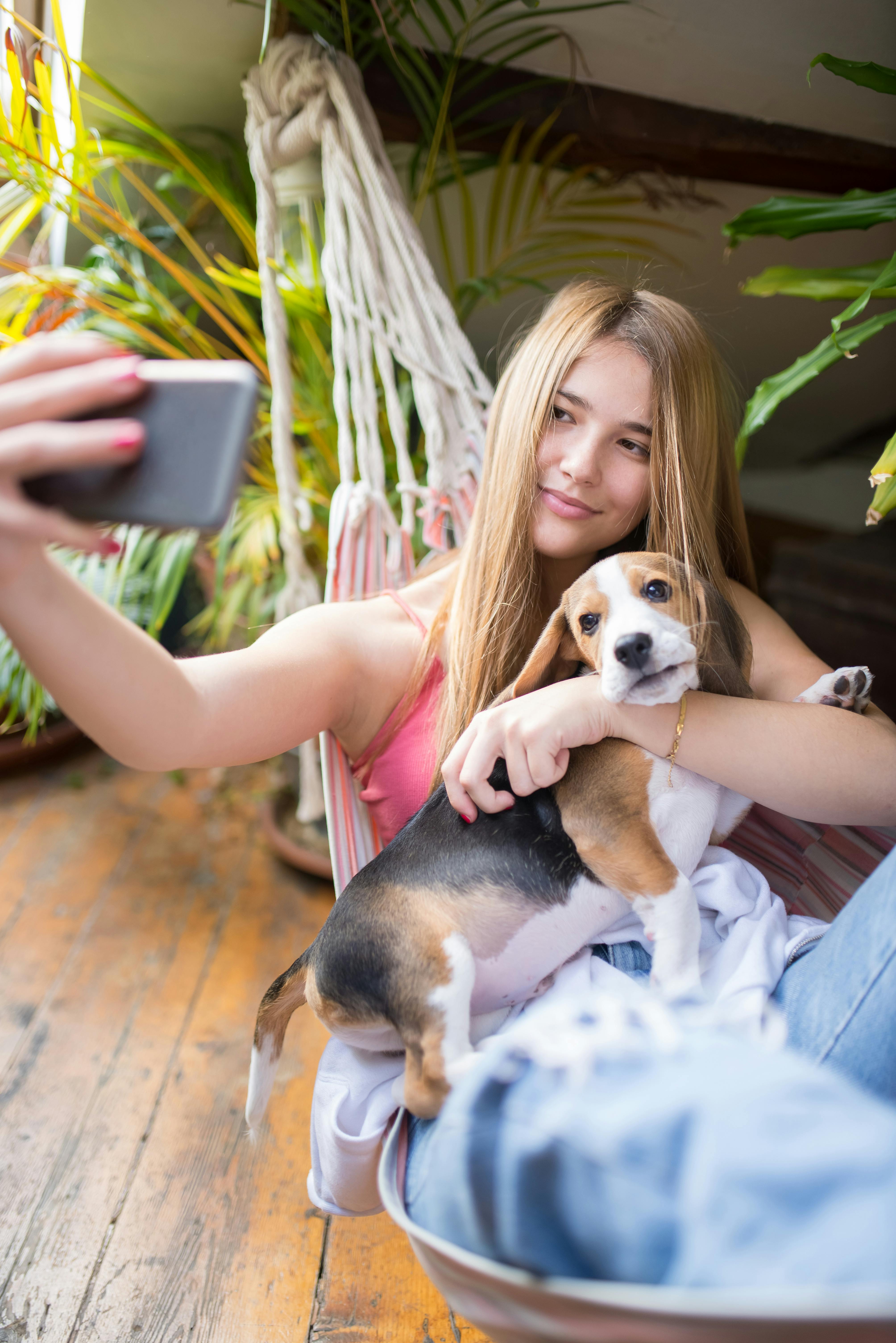 woman taking a selfie with puppy