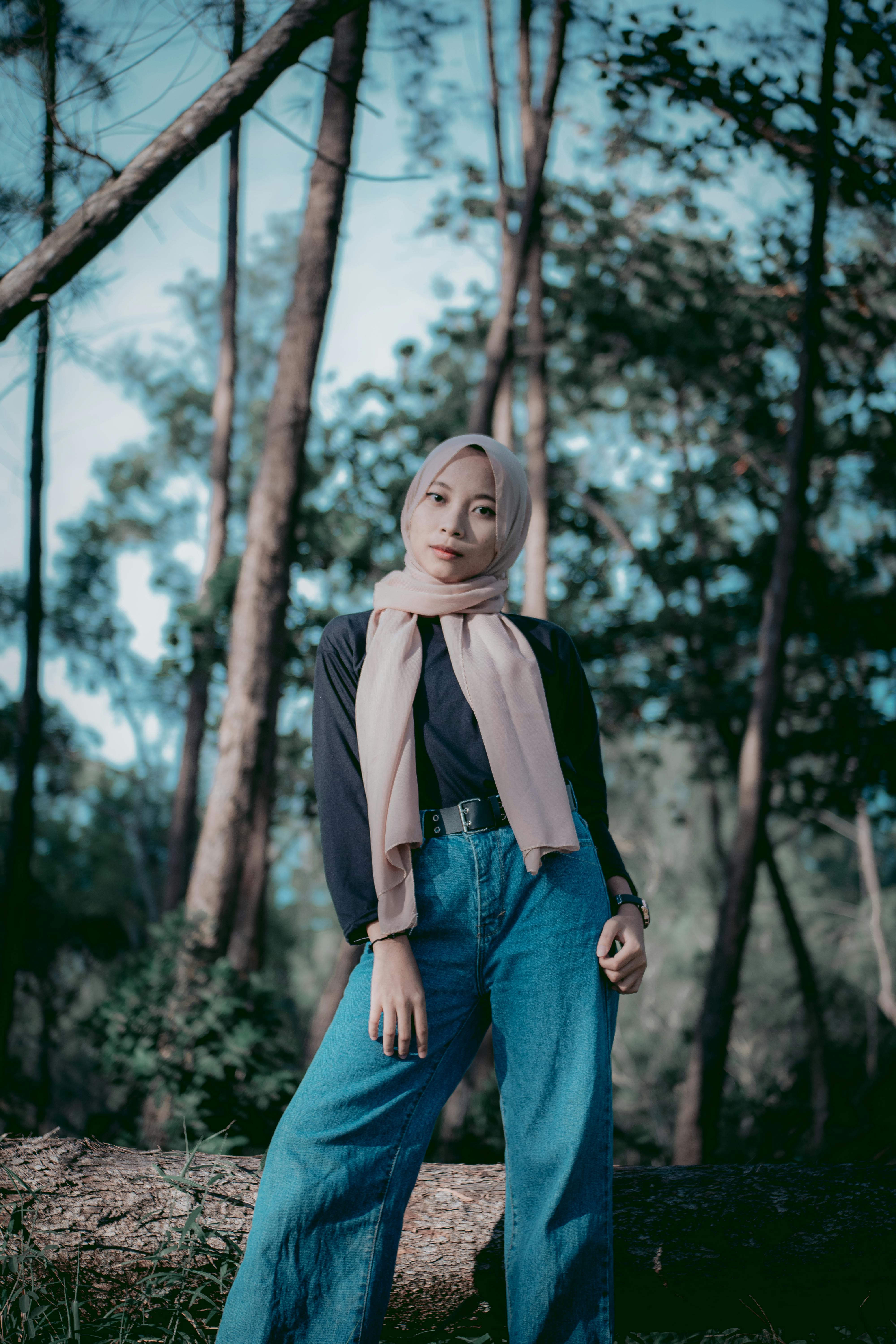 a beautiful woman in a forest, wearing hijab, looking_at camera, 