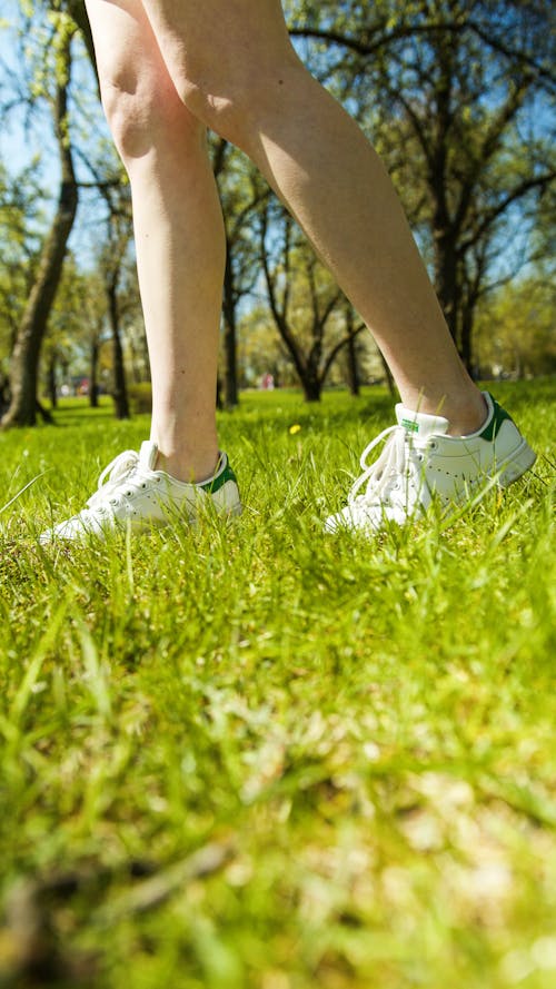 Person Standing on Green Grass