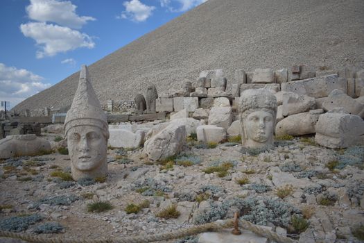 Gray Concrete Statues on Gray Sand Under Blue Sky