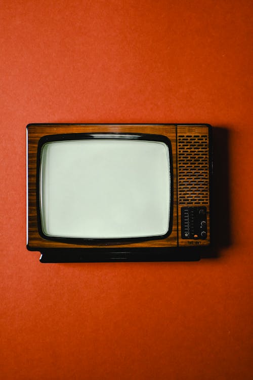 An Antique Television Set on Orange Surface
