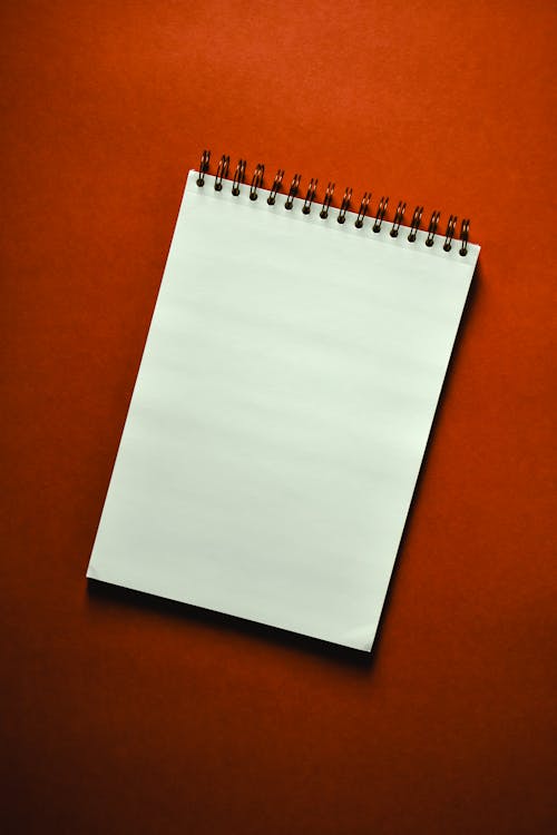 A Notepad on a Red Surface