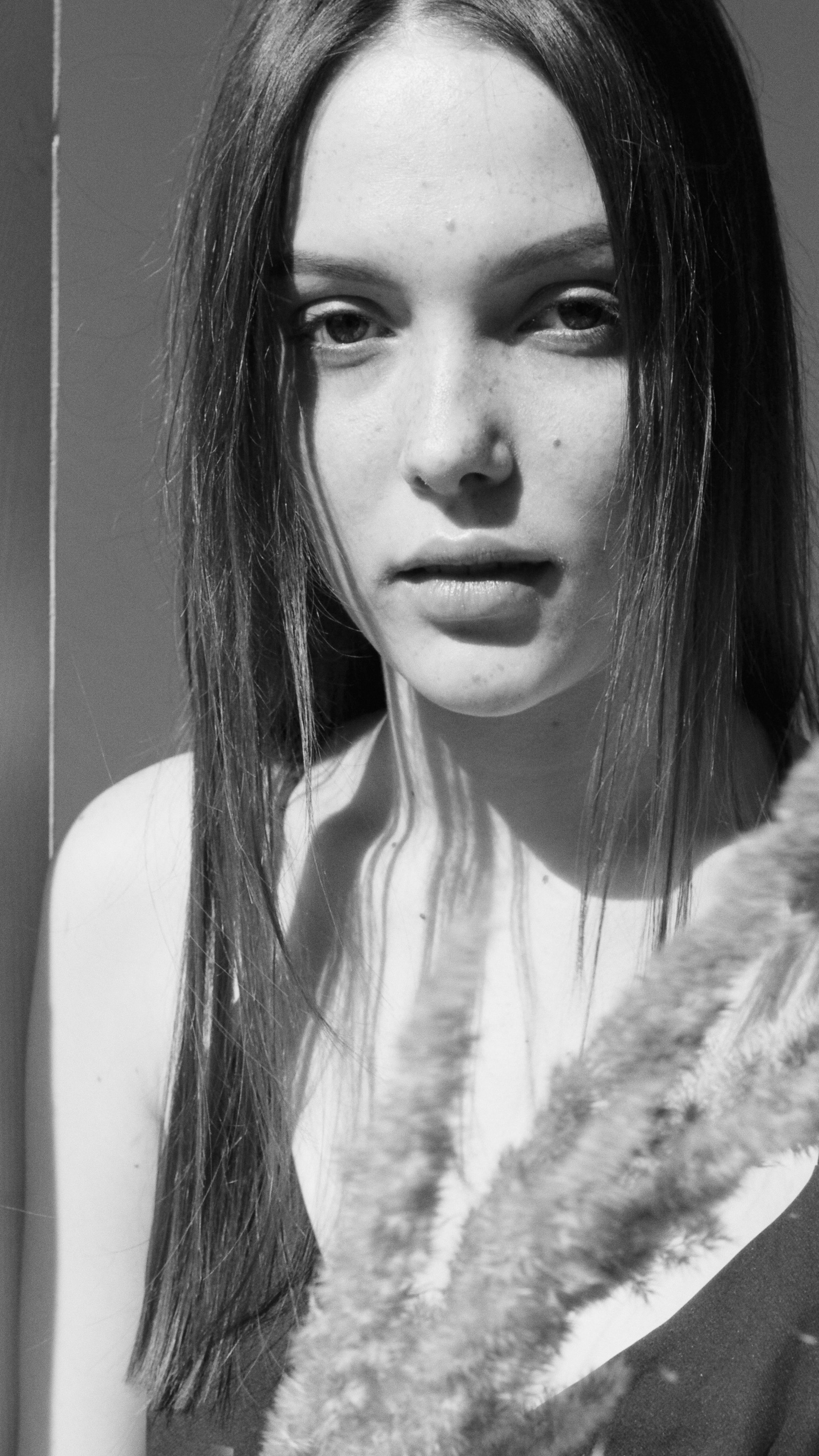 Captivating black-and-white portrait of a woman with long hair, showcasing elegance and beauty.