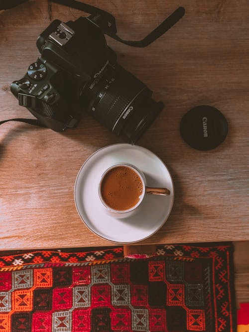 Overhead Shot of a Cup of Coffee Beside a Dslr Camera