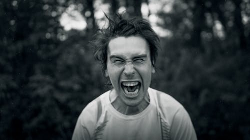Grayscale Photo of a Man with an Angry Facial Expression