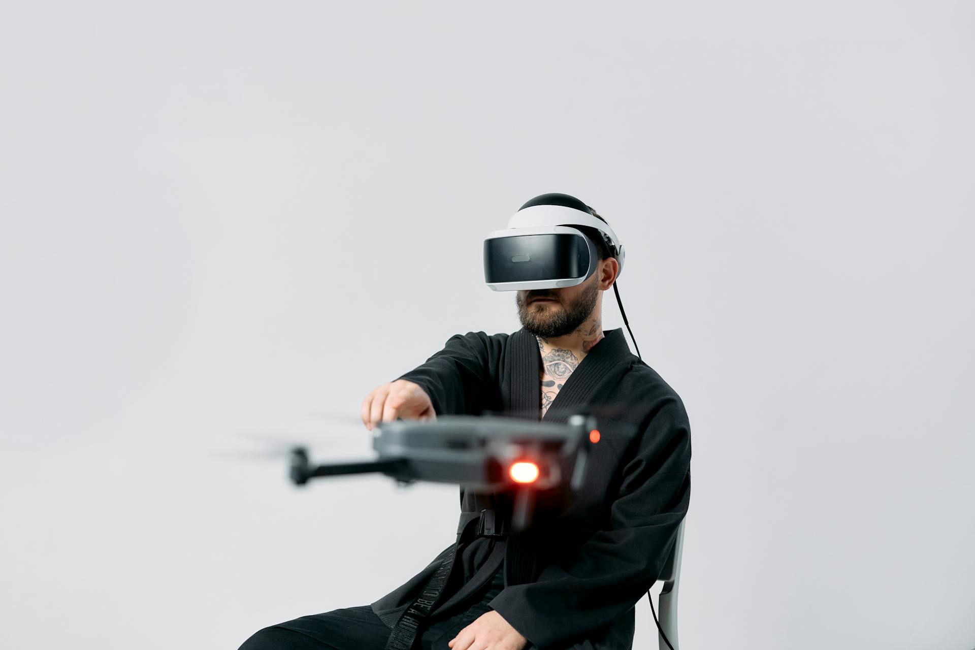 Photo of Man Pointing on a Flying Drone