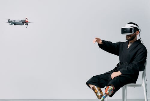 Free Photo of Man Pointing on a Flying Drone Stock Photo