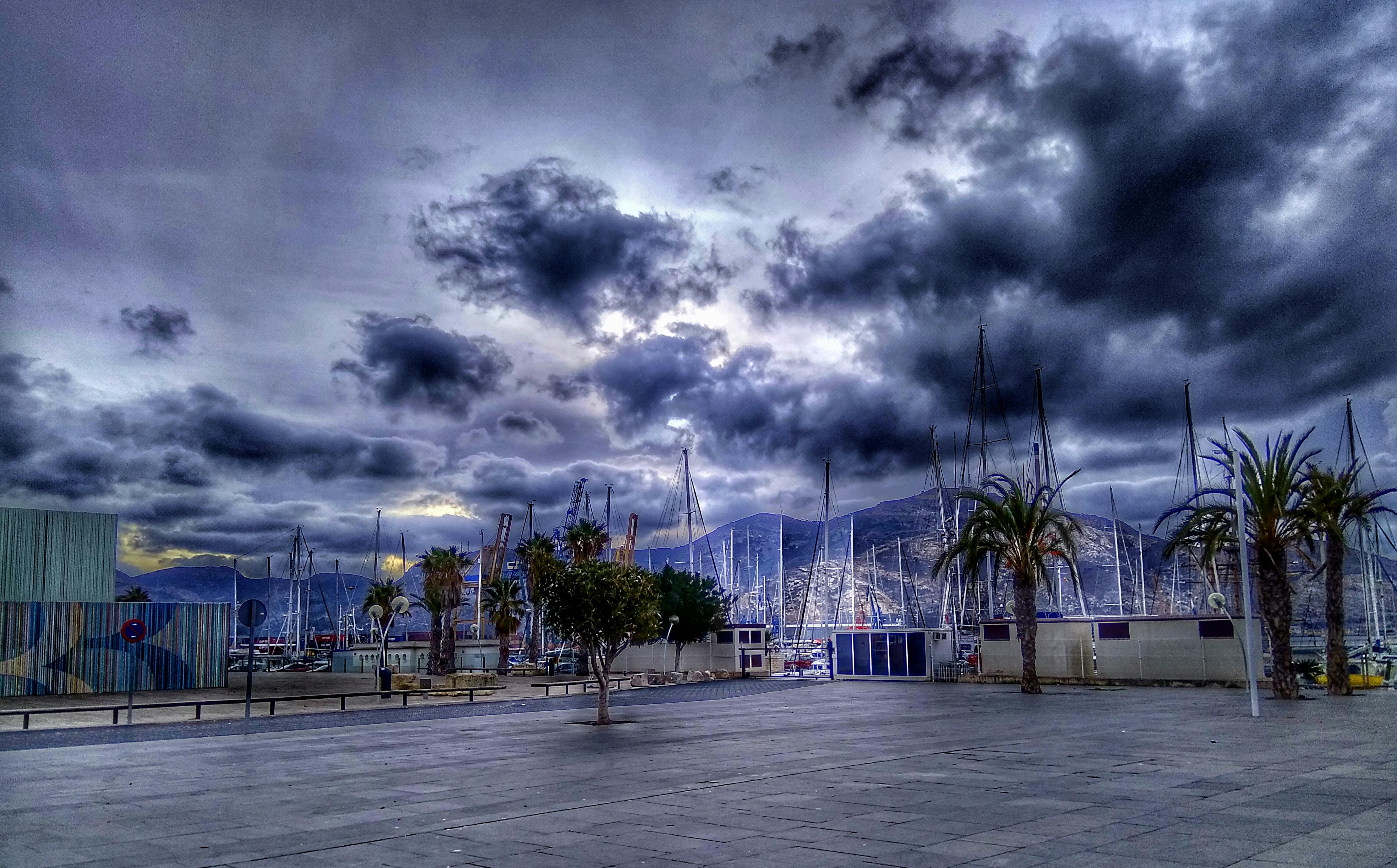 Stormy skies loom over the peaceful harbor in Cartagena, Spain.