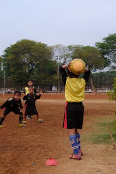 Kids enjoy a soccer game in the field, showcasing teamwork and energy.