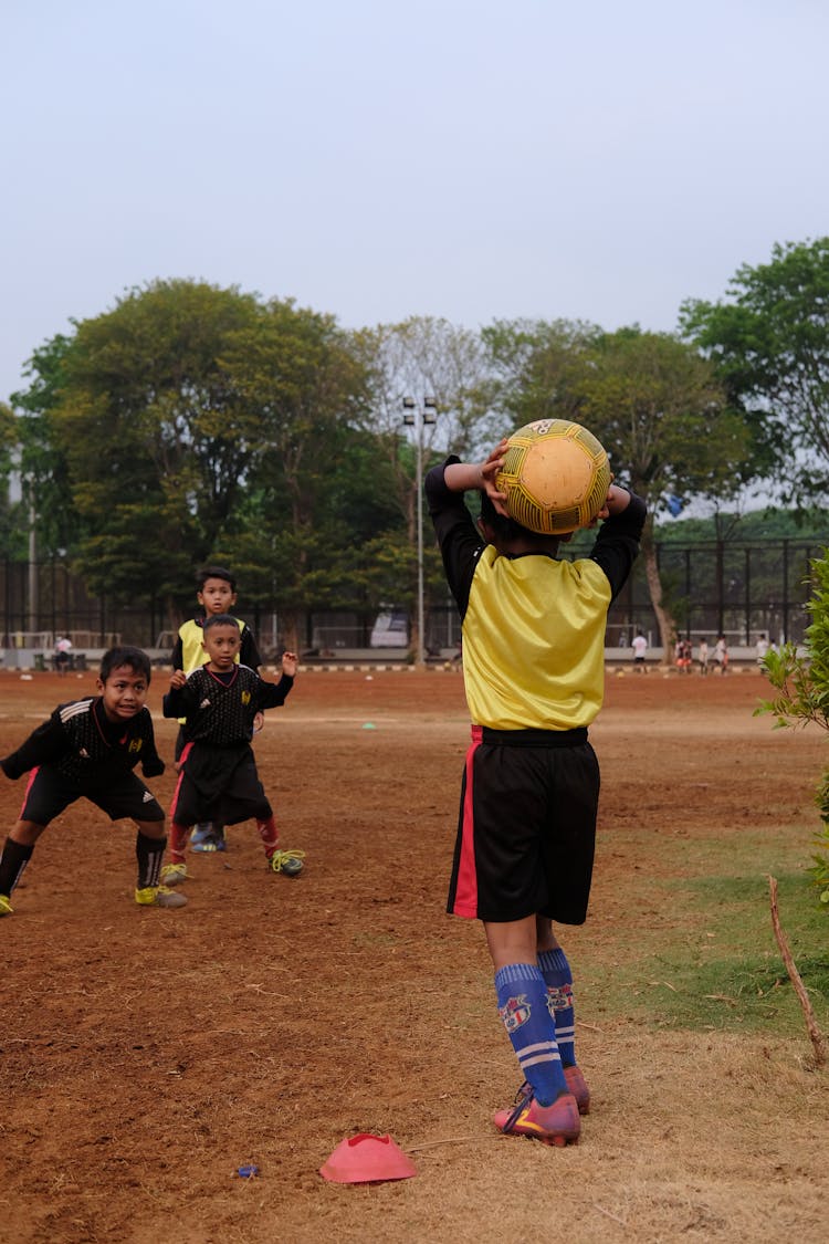 Kids Playing Soccer On The Field