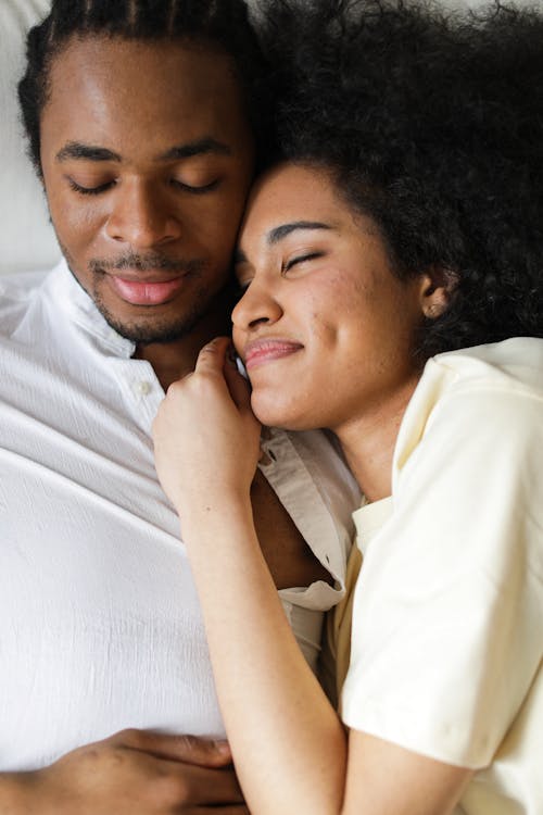 Free Photo of a Couple Lying on the Bed with Their Eyes Closed Stock Photo