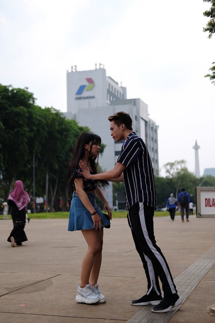 An Upset Boy Pushing Girl On Her Shoulder