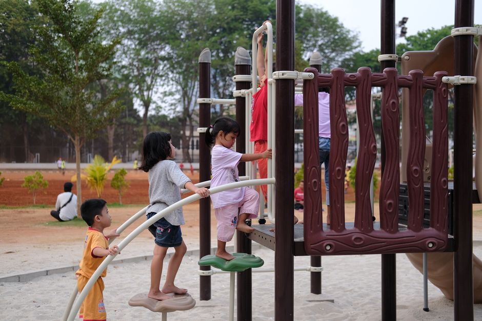 Children enjoying a day at the outdoor playground, climbing and exploring.