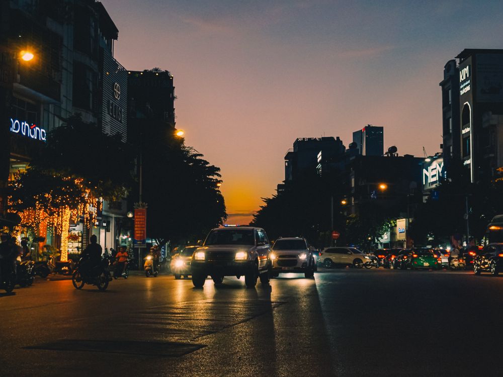 Cityscape of Hanoi at dusk featuring busy streets