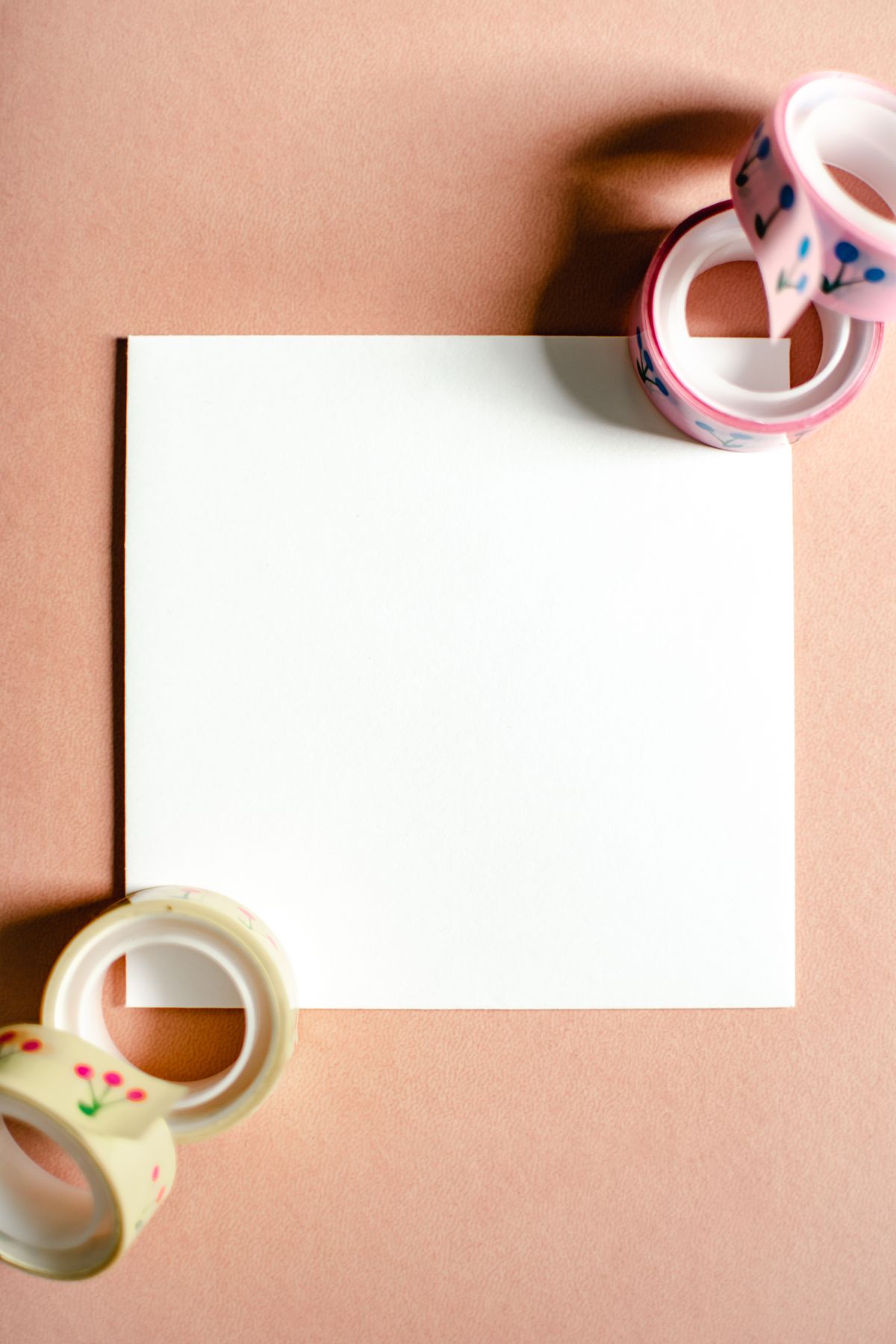 Flat lay of a blank card surrounded by colorful decorative tapes for a phone case project