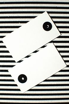 A modern minimalist image with black and white stripes and blank tags.
