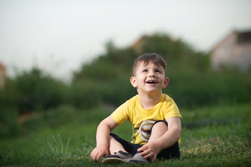 A Boy Sitting on the Grass