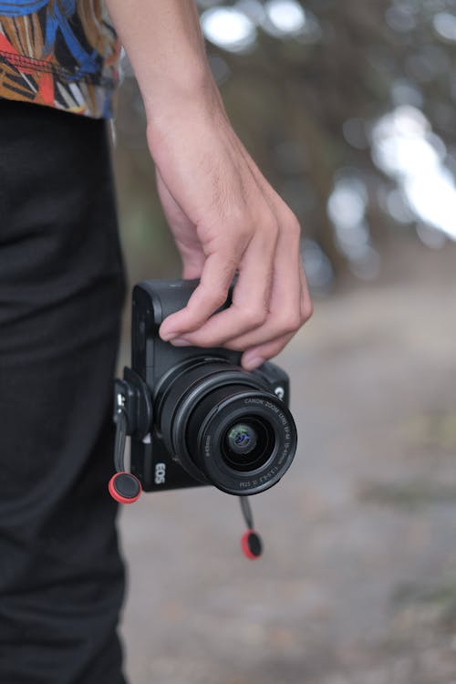 A Person Holding Black Camera