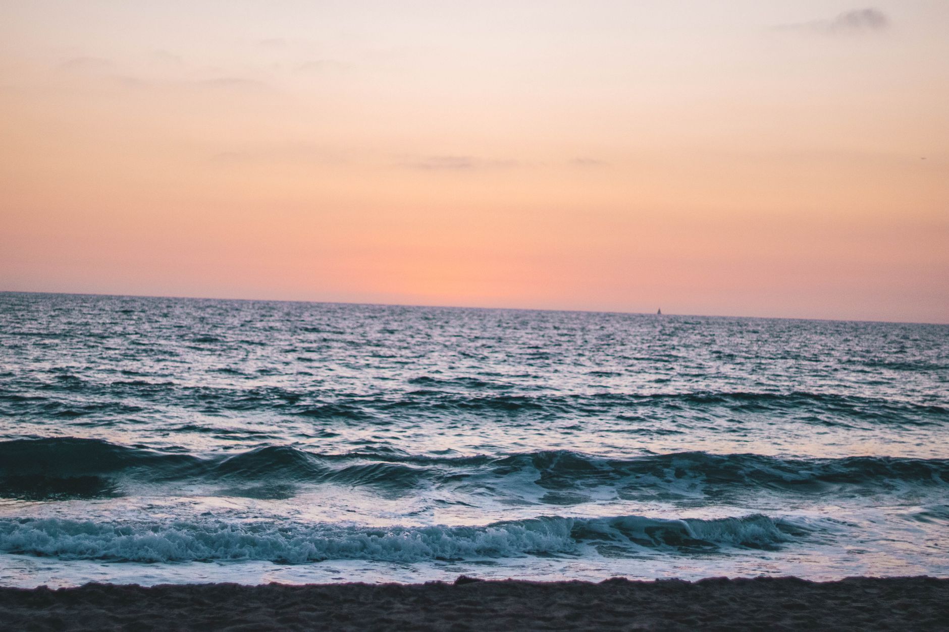 north coast beach event organizer — Calm waves and a vibrant sky at sunset on Hermosa Beach, CA.
