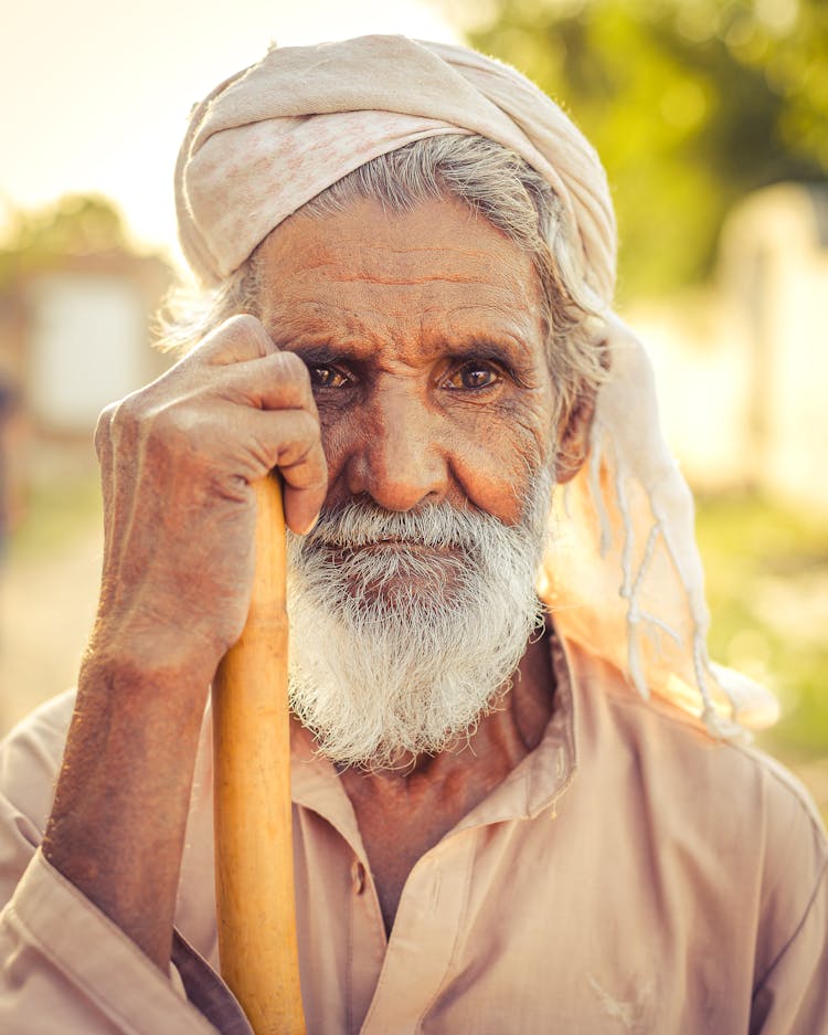 A Portrait Of An Elderly Man In A Headwrap