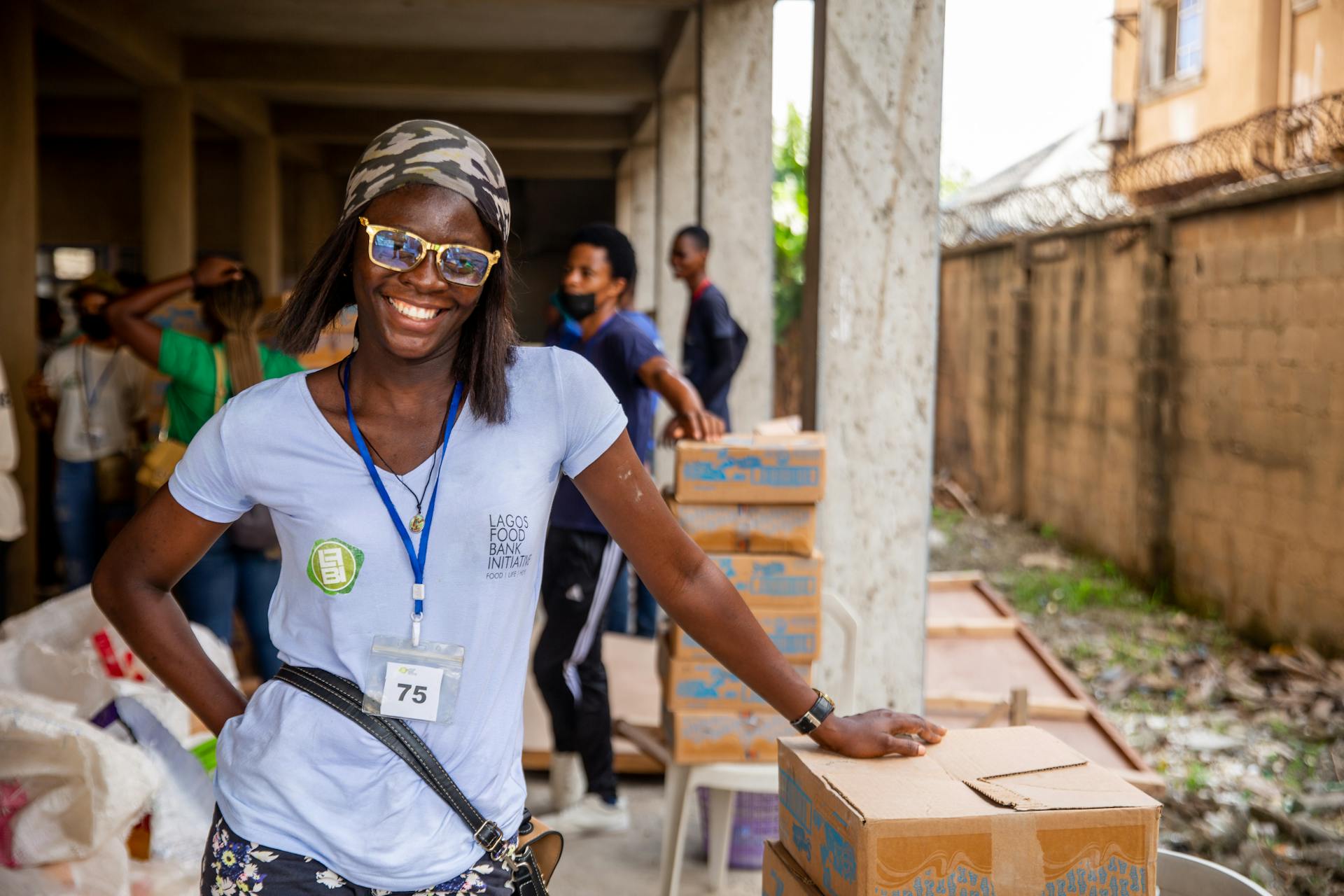 Happy volunteer engages in charity work at the Lagos Food Bank Initiative.