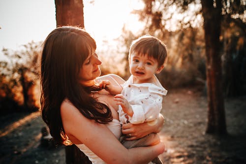 Free A Woman Holding a a Little Boy Stock Photo