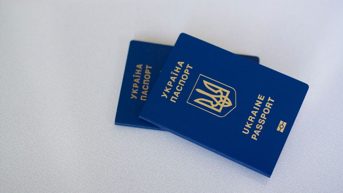 Image of two Ukrainian passports on a white surface, highlighting travel and identification themes.
