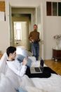 Man in Brown Crew Neck T-shirt and Blue Denim Jeans Standing Beside Man in White