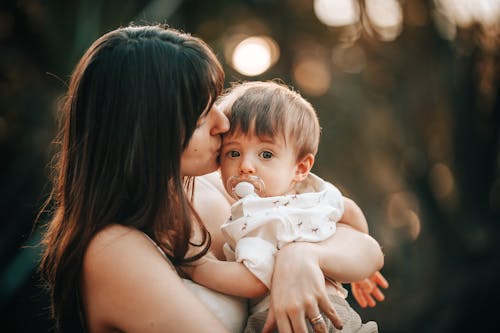 Free A Woman Kissing her Son Stock Photo
