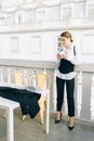 Woman in White Blazer and Black Pants Standing Beside Bed