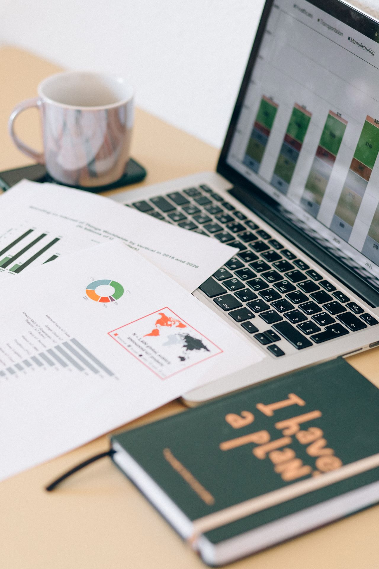 Desktop documents and laptop illustrating how information is organized.