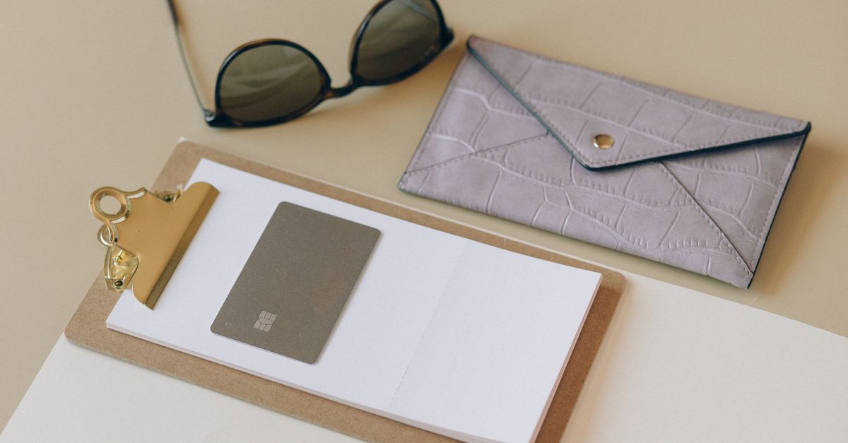 A clipboard, wallet, and papers on a tidy desk — running the numbers before the open house.