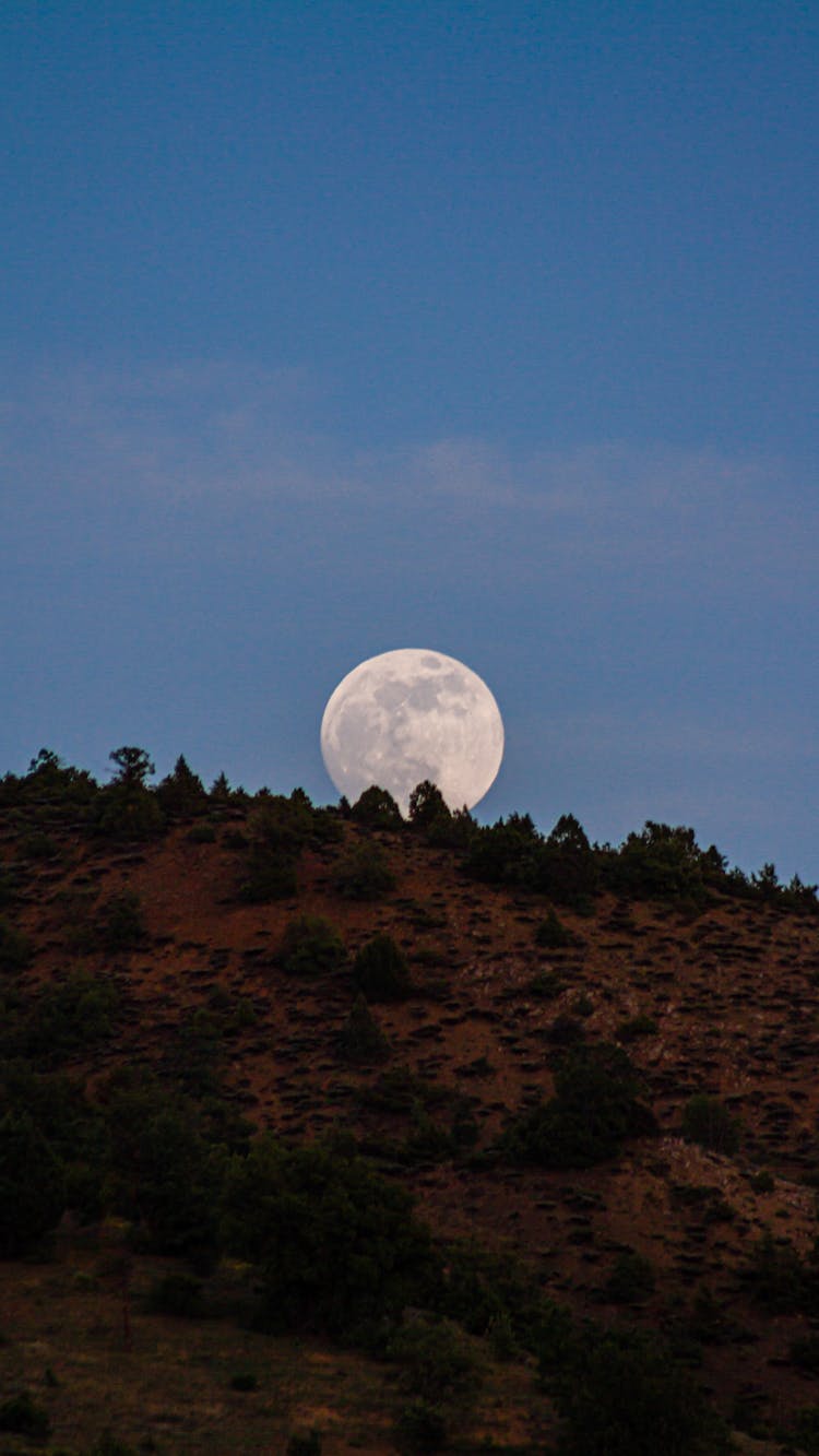 Big Moon Visible Behind A Hill 