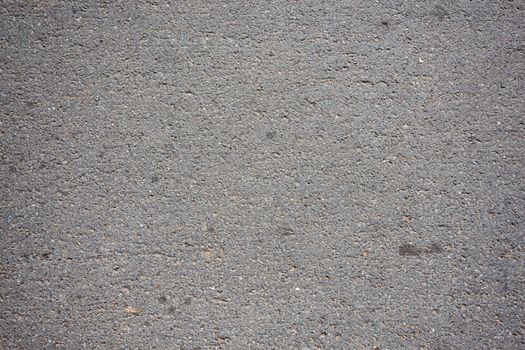 Close-up texture of a rough gray cement surface ideal for background use.