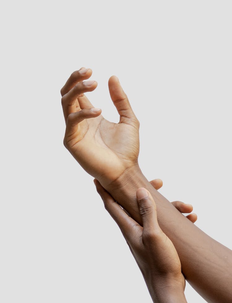 Close-Up Photo Of A Person Touching His Arm