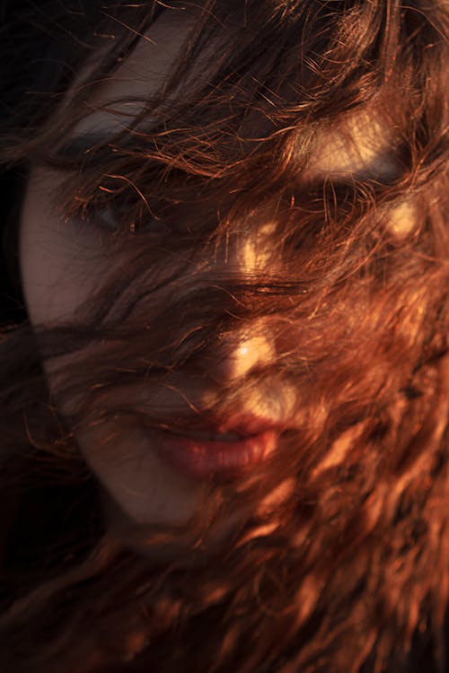 Close-up Shot of a Woman with Messy Hair Looking at the Camera
