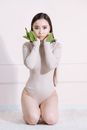 Woman in White Long Sleeve Shirt Holding Green Plant