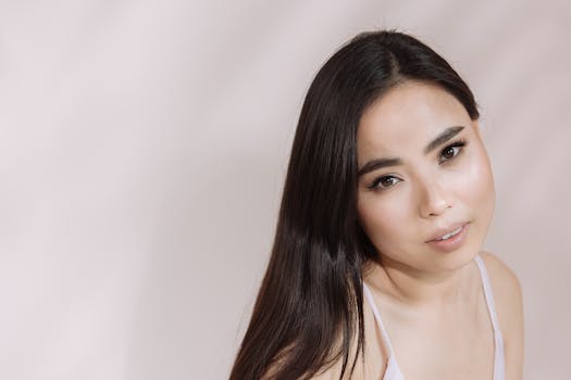 Stylish portrait showcasing the elegance and beauty of an East Asian woman in soft lighting.