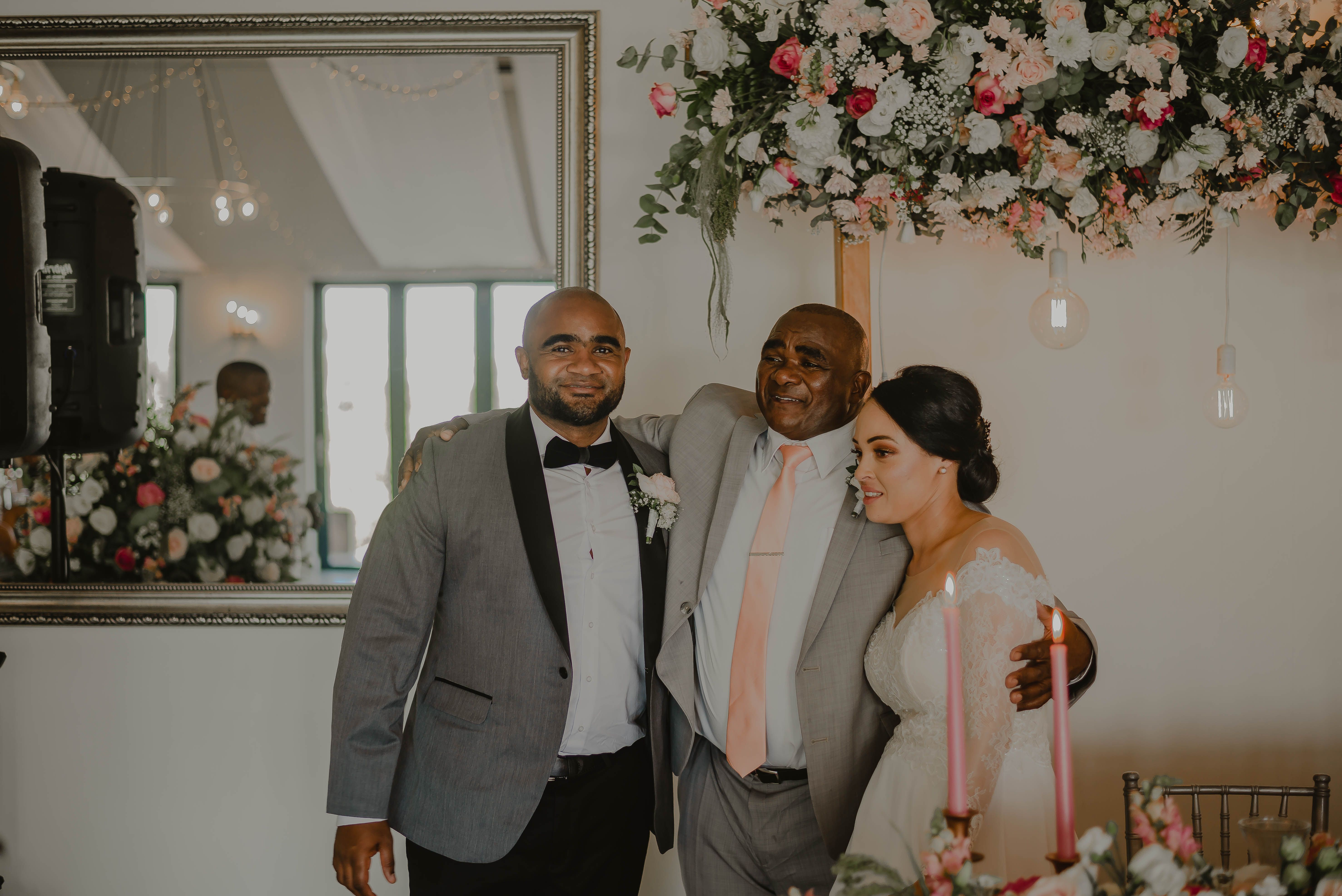 A heartwarming moment of a bride and groom celebrating with family at their wedding ceremony.