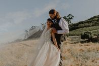 A Woman in White Wedding Gown and a Man in Black Vest