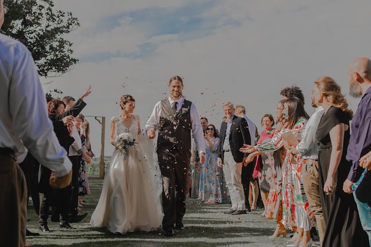 Wedding Guest Throwing Confetti At A Married Couple 