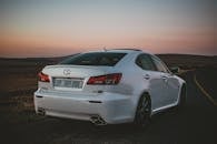 White Lexus Car Parked on the Side of an Asphalt Road