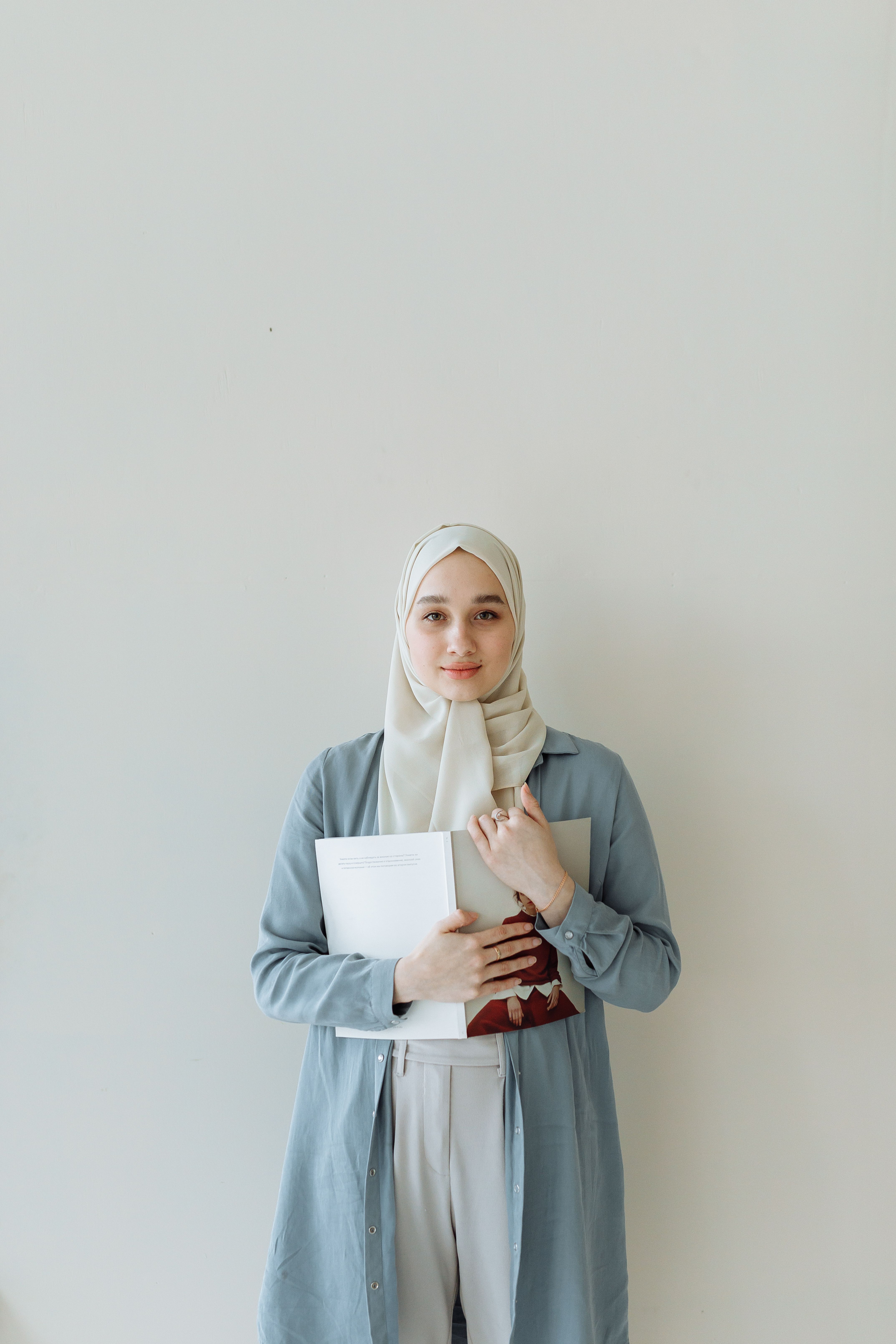 A Woman in Hijab Holding a Book · Free Stock Photo