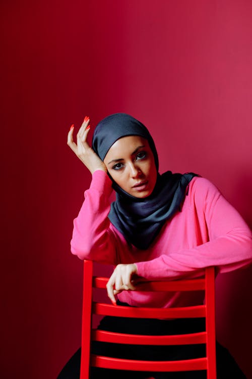 A Woman in Hijab Sitting on the Chair 
