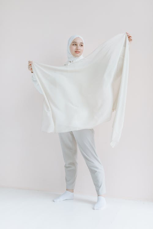 A Hijab Woman Holding a White Scarf